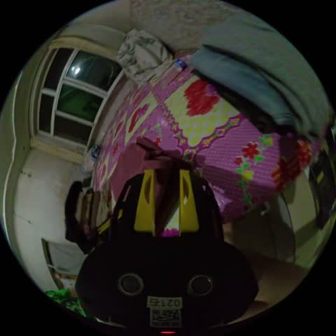 Clothes being folded on a pink floral bedspread
